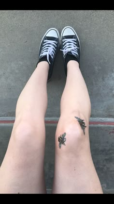 two legs with small tattoos on them and one has a bee tattoo on the leg