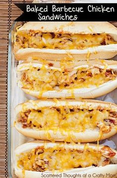 four hot dogs with cheese on them sitting in a baking dish next to each other