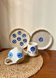 a table topped with plates and bowls filled with blue eyes