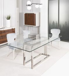 a glass dining table with white chairs and cabinets in the back ground, along with an area rug on the floor