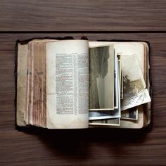 an open book sitting on top of a wooden table