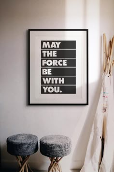 two stools in front of a poster with the words may the force be with you