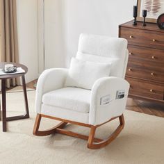 a white rocking chair in a living room