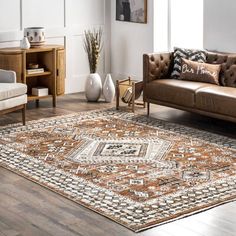 a living room filled with furniture and a large rug on top of a hard wood floor