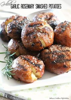 garlic rosemary smashed potatoes on a white plate