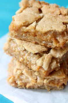 three oatmeal cookies stacked on top of each other in front of a blue background