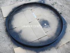 an empty tire cover sitting on top of a cement slab with the words laurie's crafty life written across it