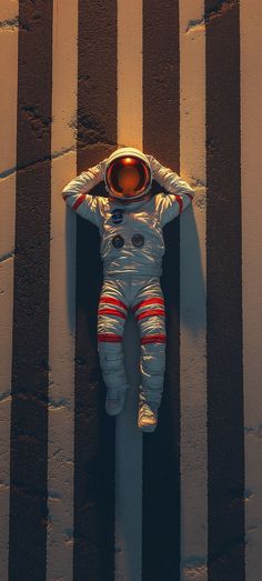 an astronaut is laying on the ground in front of a wall with vertical striped lines