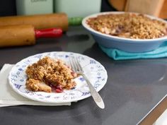 a close up of a plate of food on a table with a knife and fork