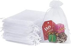 a stack of white napkins sitting on top of each other next to a bag