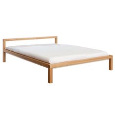 the bed frame is made from wood and has white sheets