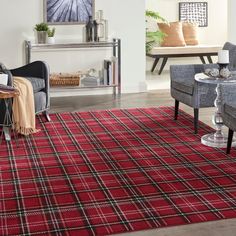 a living room filled with furniture and a red rug