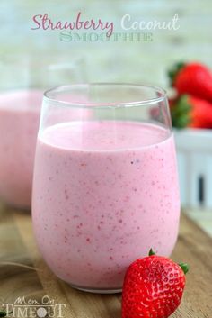 strawberry coconut smoothie in a glass next to a strawberries on a table with the words, strawberry coconut smoothie