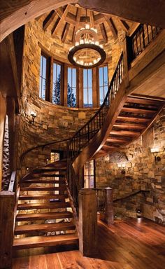 a spiral staircase in a stone and wood home