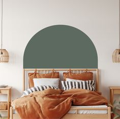 a bedroom with a large green circle wall decal on the wall above the bed