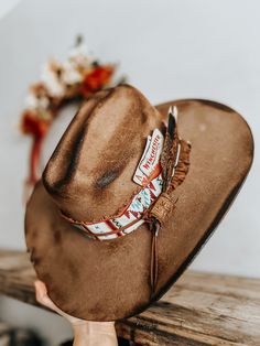 This burnt, distressed, felt fedora hat is a size 22 1/2 inches around.The hat band is an aztec and genuine leather band with a leather feather accent as well as a real feather and playing cards. This hat is burnt so it might have a slight smell for a few weeks.All feathers are glued to hold on the hat.FREE SHIPPING ON ALL OUR HAT ORDERS!All hats are branded by ©The Kiersten Zile CollectionNeed a Custom order? Message the Shop and we can start on that for you! Cowboy Hat Bands Alcohol, Custom Fedora Hat Ideas, Hat Burning Ideas, Burnt Hats, Cowboy Hat Band, Cowboy Hat Design, Diy Hats, Custom Cowboy Hats, Brown Cowboy Hat