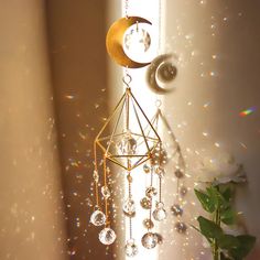 the sun is shining through the window and there are beads hanging from the wind chime