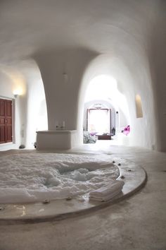 an indoor hot tub in the middle of a room with white walls and flooring