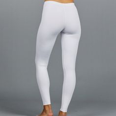 Designer Activewear.Designed and made in Miami.DESCRIPTIONUV Leggings - light solid white legging (SPF 40+ inherent in this finely knit fabric). Intended to be worn underneath any sort of choice.DETAILS & FITAthletic fit, tapered to the body.FABRIC & CARE88% Nylon / 12% SpandexSPF 40+ inherent in fabricMachine wash cold, do not bleach, tumble dry low, cool iron, do not dry clean. White Micro-elastic Tights, White Micro-elastic Yoga Activewear, White Compression Activewear For Pilates, White Compressive Yoga Pants For Pilates, Micro-elastic White Elastane Bottoms, High Stretch Seamless White Bottoms, White High Stretch Sporty Yoga Pants, White Compression Sporty Yoga Pants, Sporty High Stretch White Yoga Pants