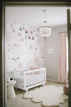 the baby's room is decorated in pink and white