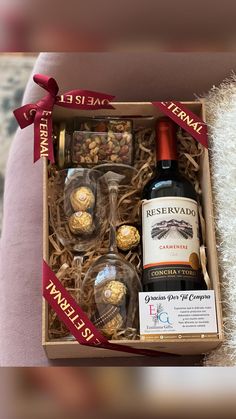 a bottle of wine and some chocolates in a box