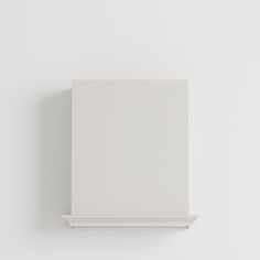 a white wall mounted shelf with a square object on it's back end and bottom corner