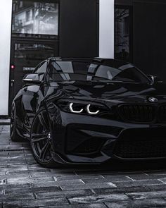 a black car parked in front of a building