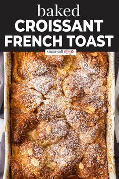 baked croissant french toast in a baking dish with powdered sugar on top