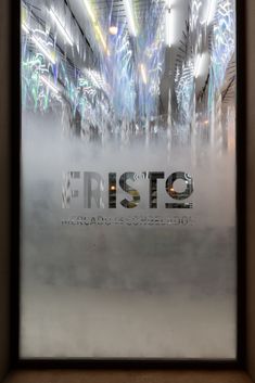 an advertisement for the first stop airport is displayed in front of a glass wall with lights