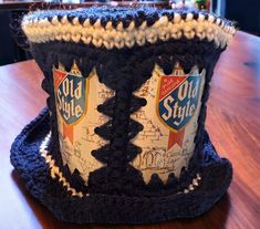 a crocheted hat sitting on top of a wooden table