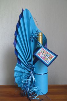 a blue gift box with an umbrella and card