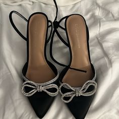 Bcbgeneration Black Heels With Silver Bedazzled Bows And Straps New And Never Worn Size 7.5 Black Heels Silver Bow, Black Ribbon Heels, Black Heels With Silver Bow, Black Heel With Bow, Silver And Black Heels, Pretty Shoes Aesthetic, Pretty Heels Prom, Black Hoco Heels, Black Heels For Prom