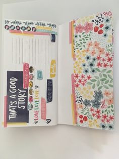 an open notebook with stickers and flowers on the pages is shown in this image