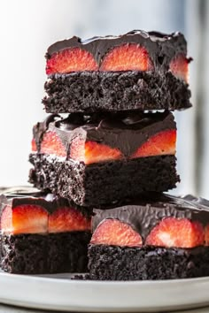 a stack of brownies with strawberries on top