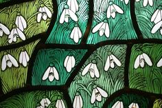 a stained glass window with white flowers on it