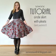 a woman standing in front of a white wall wearing a skirt with red flowers on it