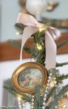 an ornament hanging from the top of a christmas tree