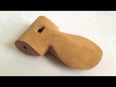 a wooden object that looks like a dog's head with holes in the side