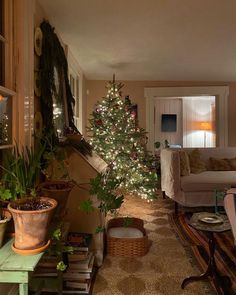 a living room filled with furniture and a christmas tree in the middle of the room