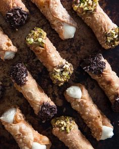 there are many different types of food on the table together, including pastry sticks and marshmallows