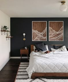 a bedroom with two paintings on the wall