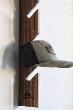 a hat is hanging on a wooden wall