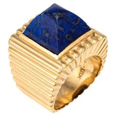 Vintage Tiffany & Co lapis lazuli ring crafted in 18 karat yellow gold (circa 1970s). Lapis lazuli measures 11mm diameter. The lapis is in good condition with some minor abrasions visible under a 10x loupe. Dating to the 1970s the 18k gold ring is styled in a ridged square design. The sugarloaf cut cobalt blue lapis lazuli makes a great statement. The ring is a great example of 70s era design with a bold, distinct look that makes an impact on the finger. The ring has a weighty, solid feel on the Masonic Jewelry, 1970s Jewelry, Russian Jewelry, Antique Jewelry Rings, Lapis Lazuli Jewelry, Lapis Lazuli Ring, 18k Gold Ring, Art Nouveau Jewelry, Tiffany And Co