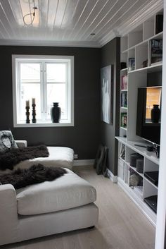 a living room filled with furniture and a flat screen tv