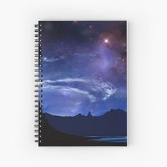 a spiral notebook with the night sky and stars in the background, as well as mountains