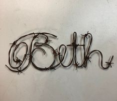 the word faith is made out of barbed wire