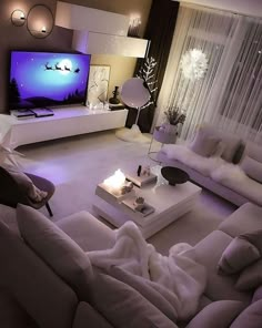 a living room filled with furniture and a flat screen tv on top of a wall