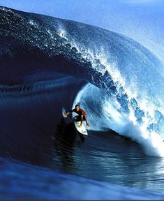 a man riding a wave on top of a surfboard