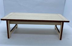 a small wooden table sitting on top of a white floor