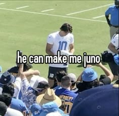 a group of people standing on top of a soccer field with the words he can make me uno